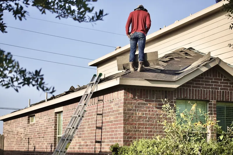 Professional roofer working on a residential roof in The Crossings